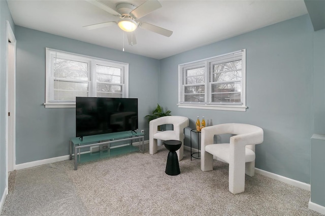 sitting room with a healthy amount of sunlight, ceiling fan, and carpet flooring
