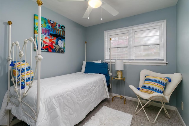 carpeted bedroom featuring baseboards and ceiling fan