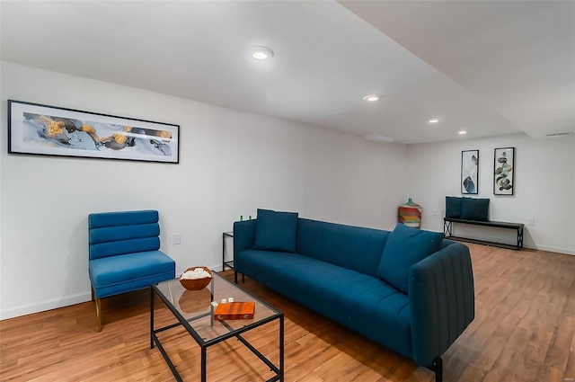 living room with baseboards, recessed lighting, and light wood-style flooring