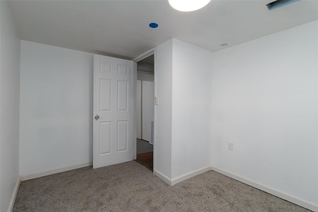 unfurnished bedroom with carpet flooring, baseboards, and visible vents
