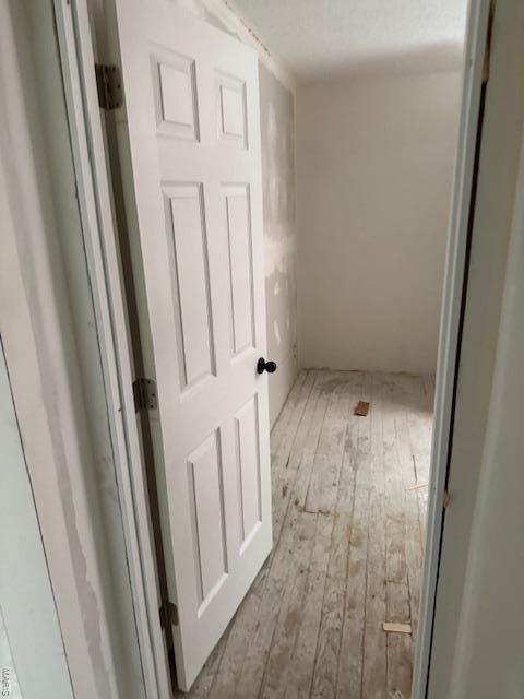 corridor featuring wood-type flooring