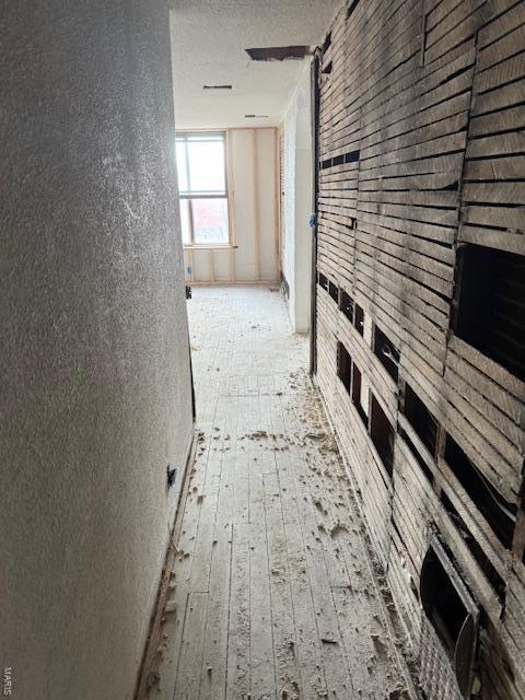 hallway featuring a textured ceiling