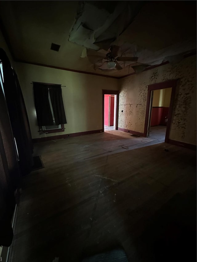 unfurnished room featuring ceiling fan and baseboards