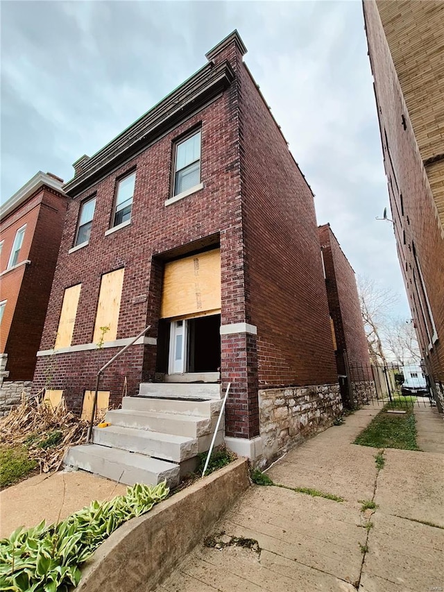 exterior space featuring entry steps and brick siding