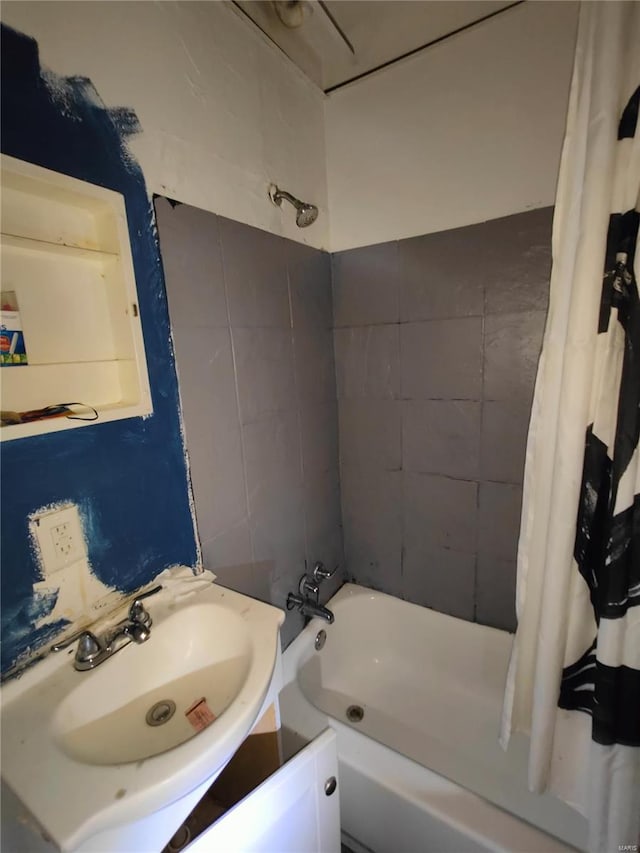 bathroom with vanity, tile walls, and shower / bath combo