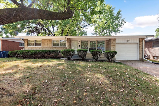 ranch-style house with brick siding, a front lawn, concrete driveway, and an attached garage