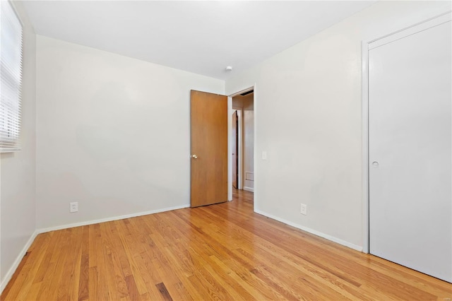 unfurnished bedroom featuring baseboards and light wood-style flooring