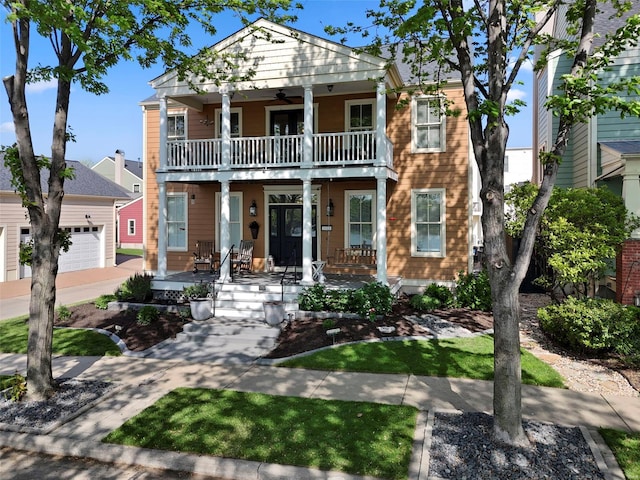 view of front of home featuring a porch, ceiling fan, a balcony, and a garage