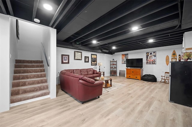 living room with light wood-type flooring and stairs
