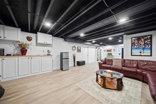 living room featuring light wood-type flooring and baseboards