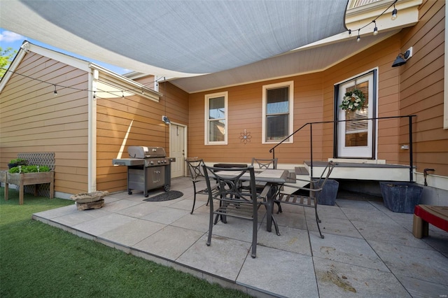 view of patio / terrace featuring outdoor dining area and a grill