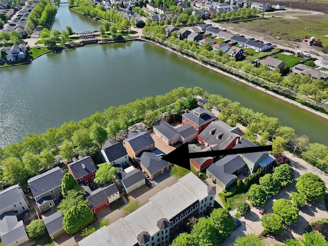 birds eye view of property with a water view and a residential view