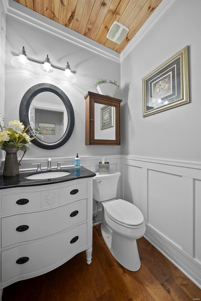half bath with wainscoting, vanity, wood-type flooring, toilet, and wood ceiling
