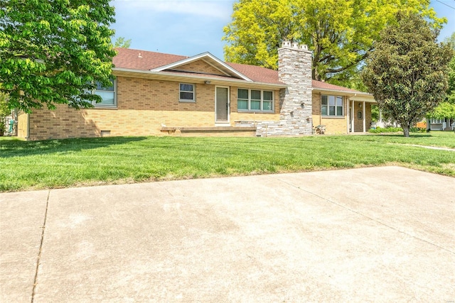 single story home with crawl space, a chimney, brick siding, and a front yard