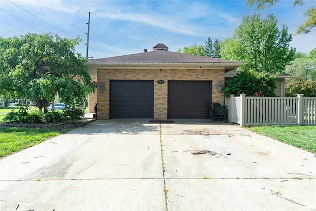 detached garage featuring fence