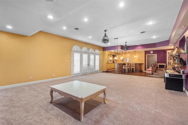 carpeted living room featuring stairway, baseboards, visible vents, and recessed lighting