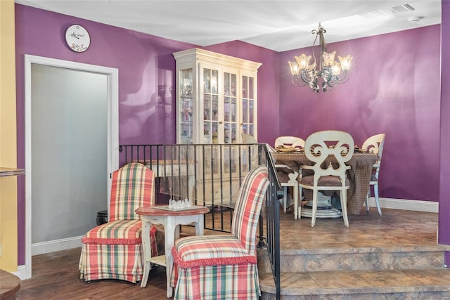 dining area featuring baseboards and a chandelier