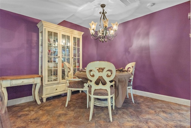dining space with an inviting chandelier and baseboards