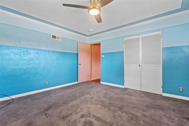 unfurnished bedroom featuring carpet, visible vents, and ornamental molding