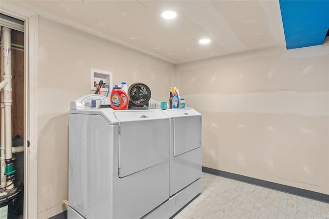 laundry room featuring washing machine and dryer, laundry area, recessed lighting, and light wood-style floors