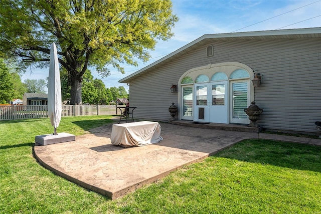 back of property featuring a yard, fence, and a patio