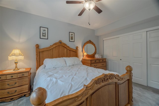 bedroom with a closet, a ceiling fan, and light carpet