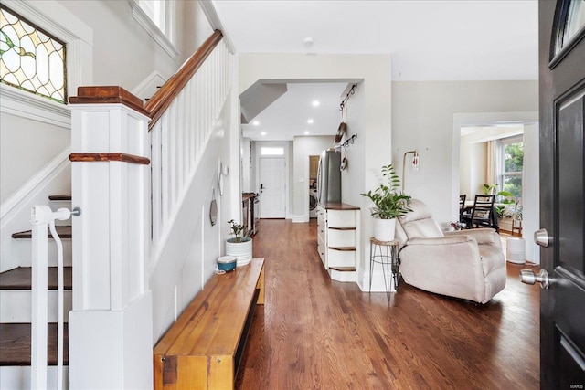foyer with recessed lighting, dark wood-style flooring, and stairs