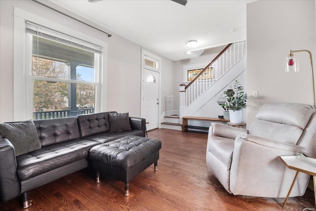 living room with wood finished floors and stairway