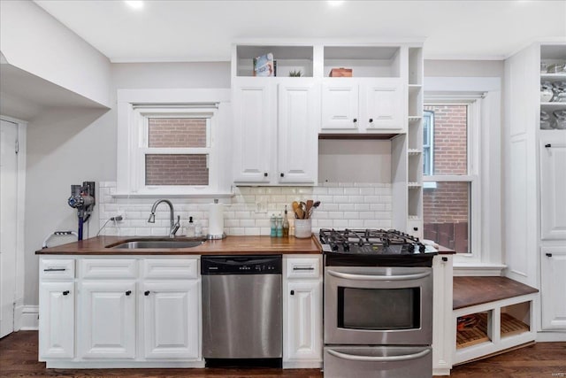 kitchen with a sink, open shelves, white cabinets, and stainless steel appliances