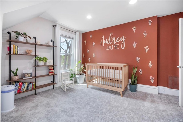 carpeted bedroom featuring visible vents, lofted ceiling, an accent wall, baseboards, and recessed lighting