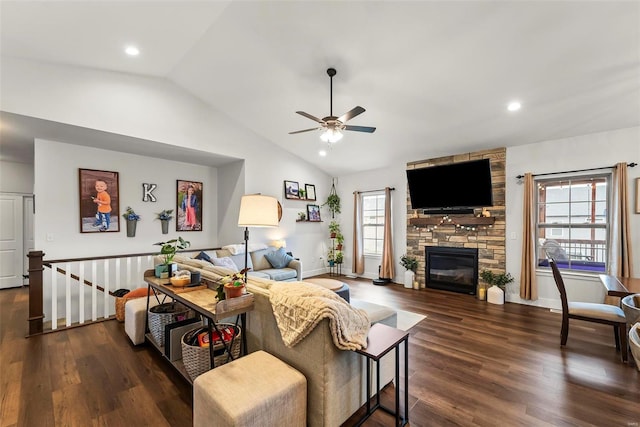 living area featuring a ceiling fan, dark wood-style flooring, vaulted ceiling, and a fireplace