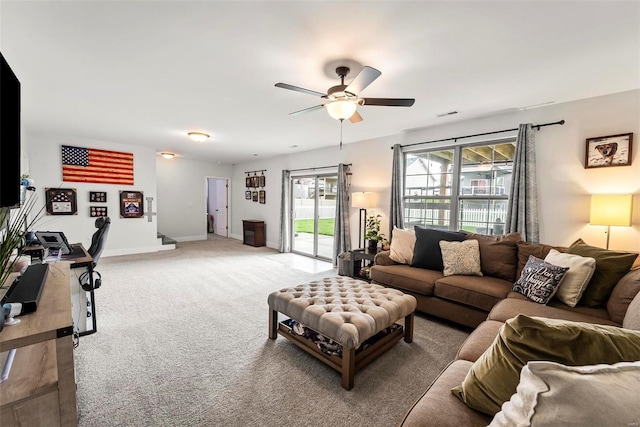 living area with light colored carpet, a ceiling fan, baseboards, and visible vents