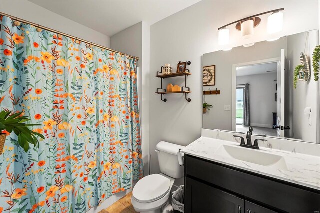 bathroom featuring toilet, a shower with curtain, and vanity