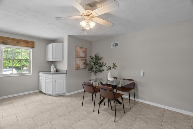 dining room featuring a ceiling fan, baseboards, visible vents, and light tile patterned floors