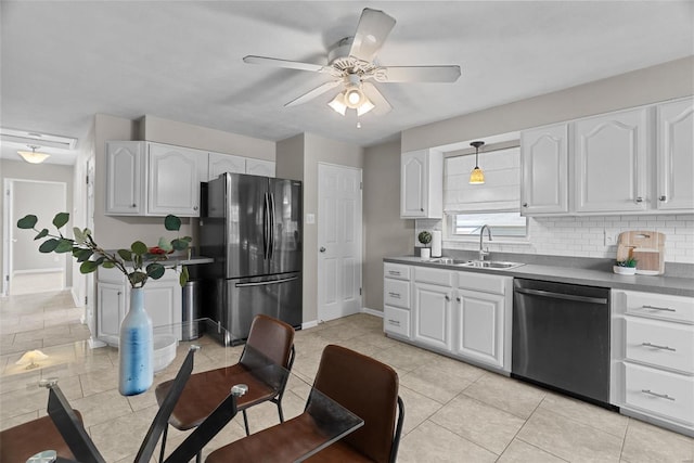 kitchen with white cabinets, a sink, freestanding refrigerator, a ceiling fan, and dishwashing machine