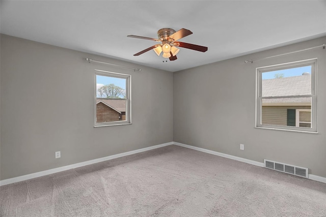 unfurnished room with a ceiling fan, baseboards, visible vents, and carpet