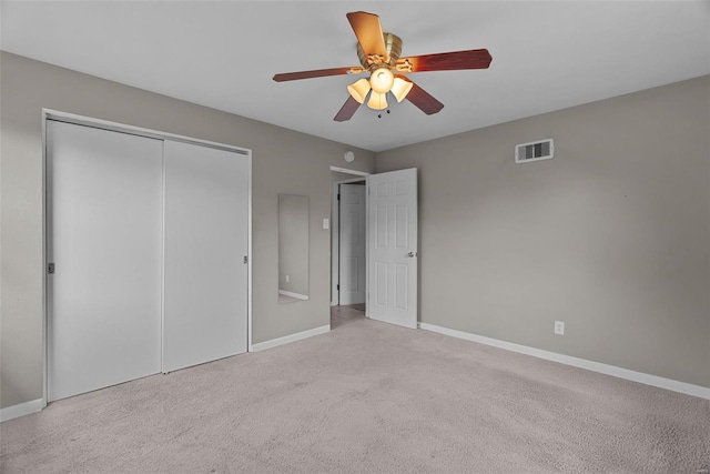 unfurnished bedroom featuring carpet flooring, a ceiling fan, baseboards, visible vents, and a closet