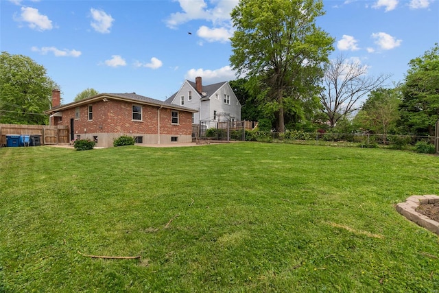 view of yard with fence and a patio area
