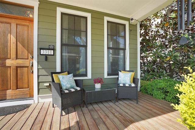 wooden terrace featuring covered porch