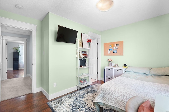 bedroom with baseboards and dark wood-type flooring