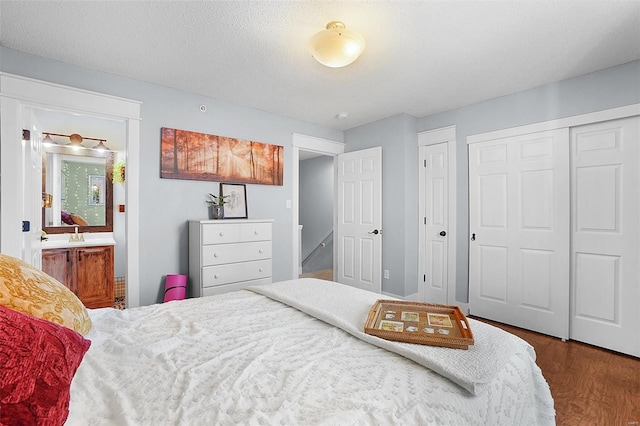 bedroom featuring connected bathroom and wood finished floors