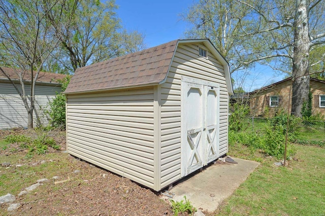 view of shed with fence
