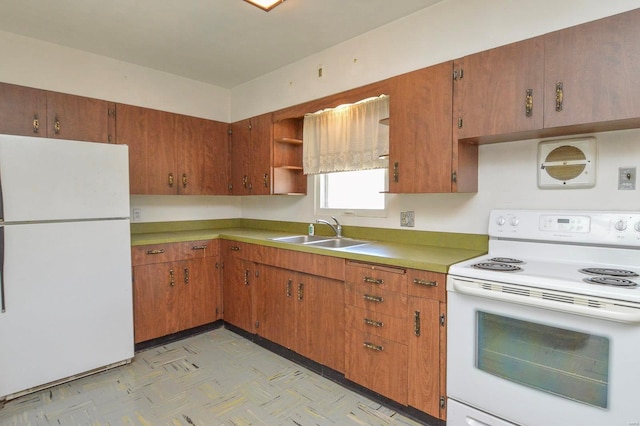 kitchen featuring white appliances, open shelves, brown cabinetry, and a sink