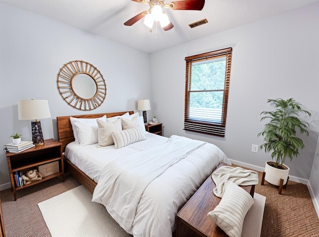 bedroom with visible vents, carpet flooring, and baseboards