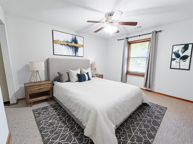bedroom with baseboards, carpet, a ceiling fan, and visible vents