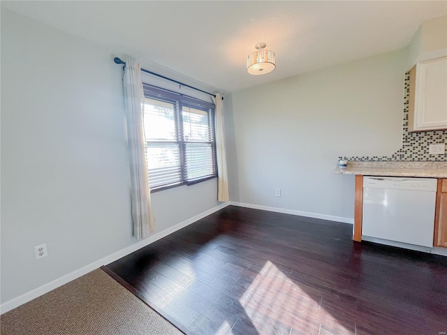 unfurnished living room with baseboards and dark wood-style flooring
