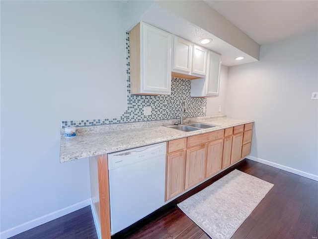 kitchen featuring baseboards, a sink, dark wood-style flooring, and dishwasher