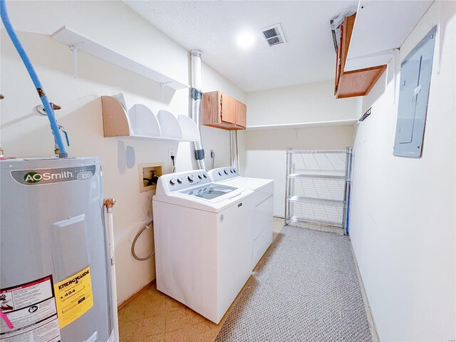 clothes washing area featuring visible vents, washer and clothes dryer, electric panel, electric water heater, and cabinet space