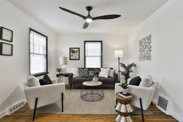 living area with a healthy amount of sunlight, ceiling fan, and visible vents