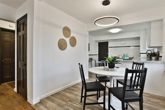 dining room featuring baseboards and light wood-style floors
